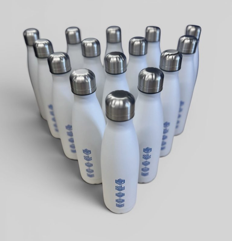 Branded exhibition giveaways including tote bags, water bottles and notebooks