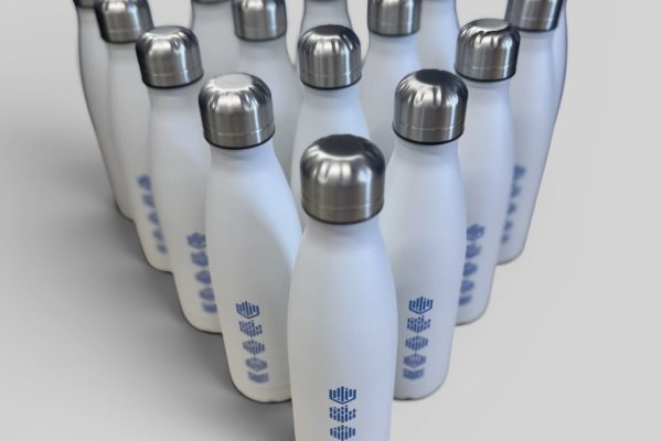 Branded exhibition giveaways including tote bags, water bottles and notebooks